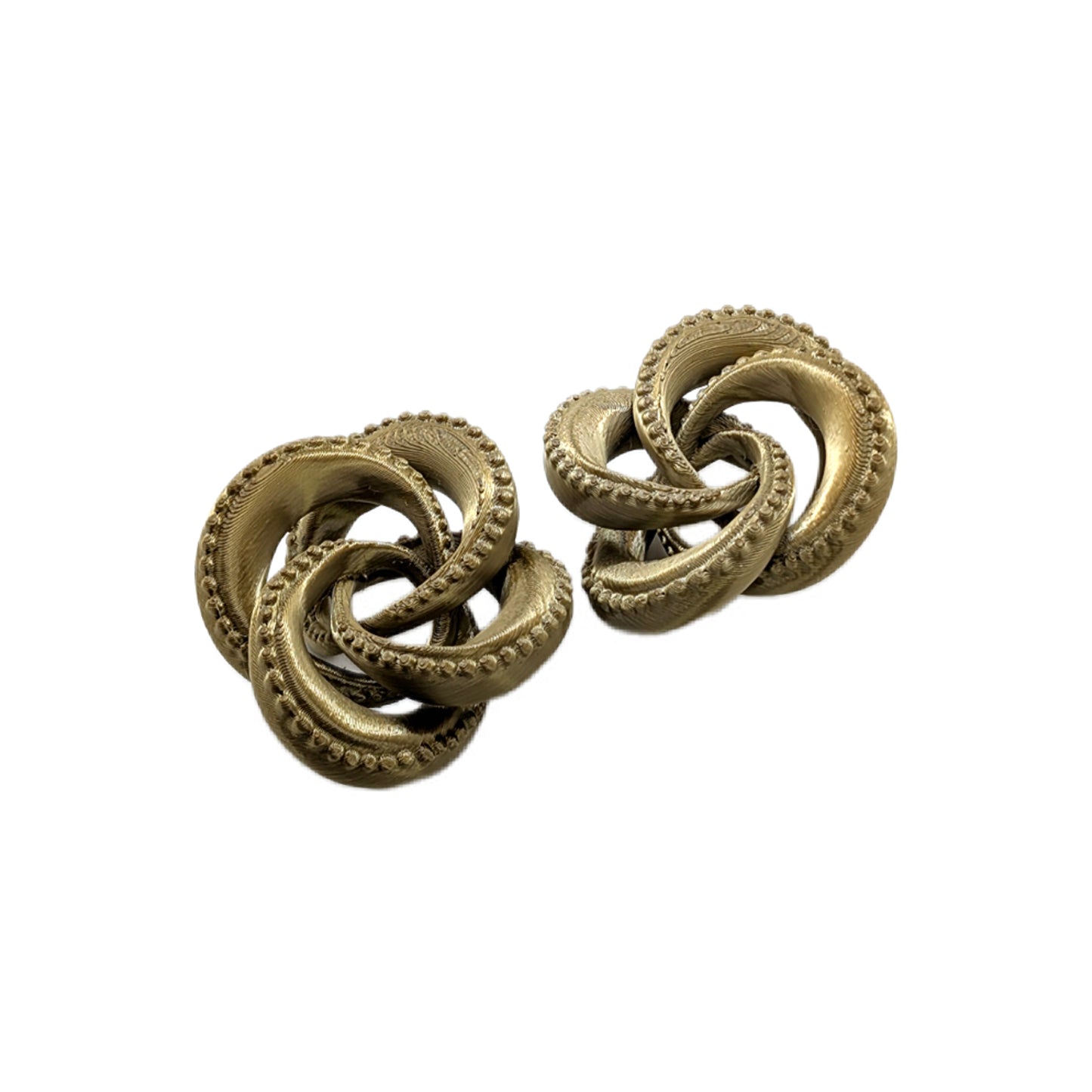 Pair of gold knot earrings on a white background