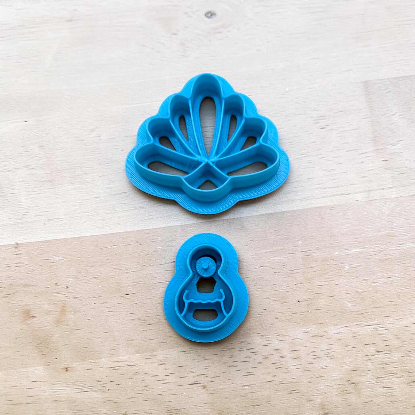 Blue 3D‑printed Turkey and Feathers (Style B) cookie cutter set on a wooden surface, designed for cookies, fondant, polymer clay, ceramics, and pottery crafting.