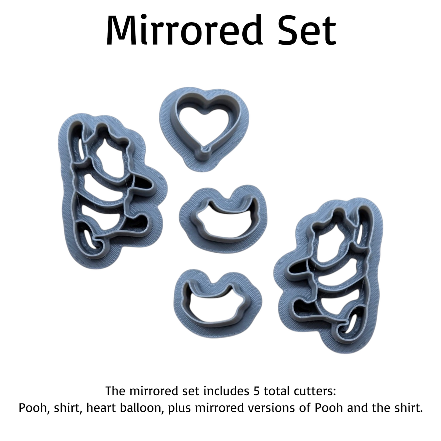 Mirrored set of five plastic cookie cutters on a white background, including Pooh, shirt, heart balloon, and mirrored versions of Pooh and the shirt. Text at top reads 'Mirrored Set' with descriptive text at the bottom.