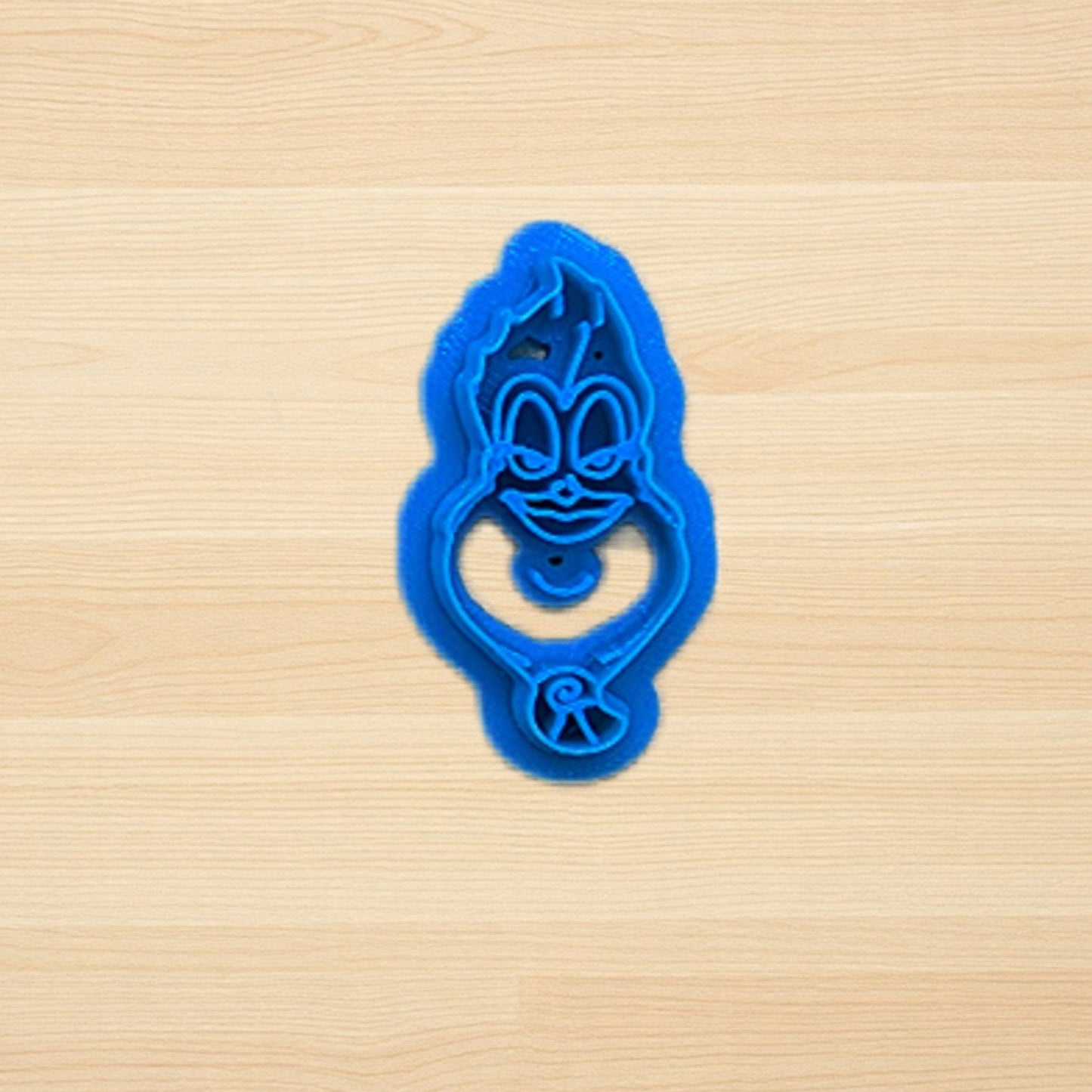 Blue Ursula Sea Witch Little Mermaid cookie cutter on a wooden surface