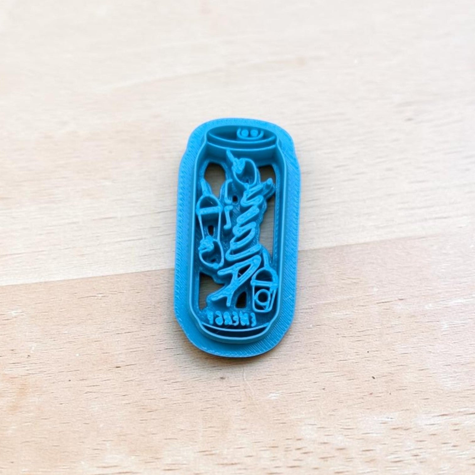 Blue 3D‑printed Alani Nu energy drink can cookie cutter on light wood background — perfect for cookies, fondant, and polymer clay.