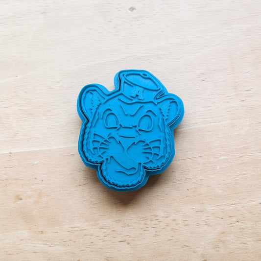 Auburn Tiger cookie stamp and cutter set – blue 3D‑printed polymer clay tool featuring cartoon tiger face with hat and letter A for cookies, fondant, and pottery projects.