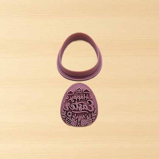 Purple, plastic Easter egg cutter and stamp set on a wood surface