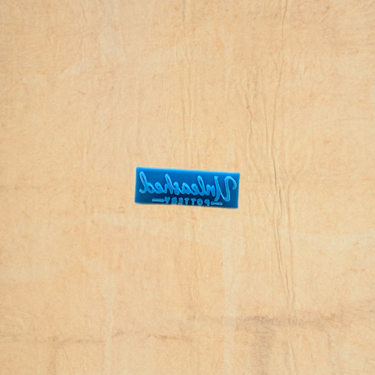 Blue stamp with text on a beige fabric background