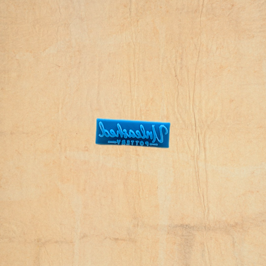 Blue stamp with text on a beige fabric background