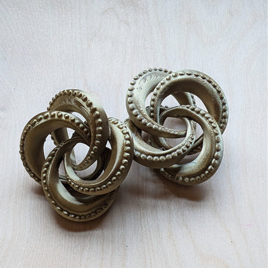 Large, 3D printed, antique gold tentacle knot earrings. 