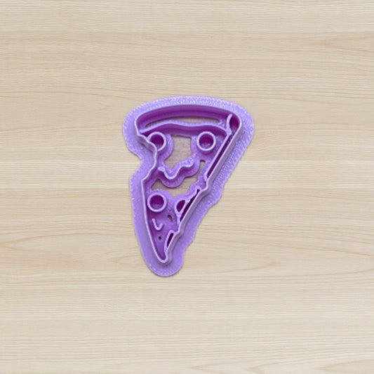 Purple pizza slice cookie cutter on a wooden surface