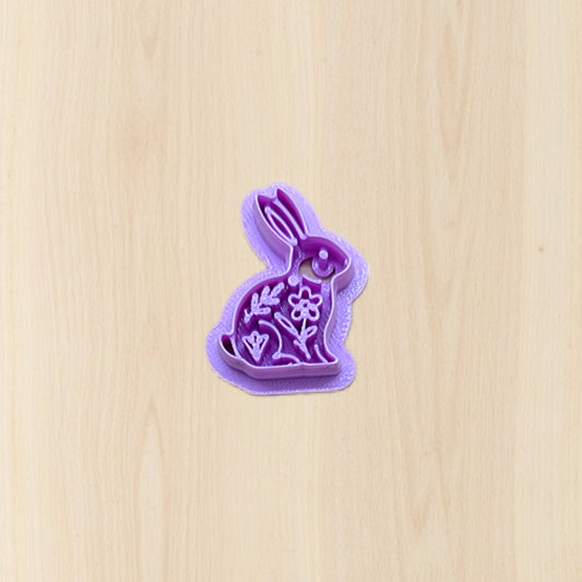 Purple bunny-shaped cookie cutter on a wooden surface