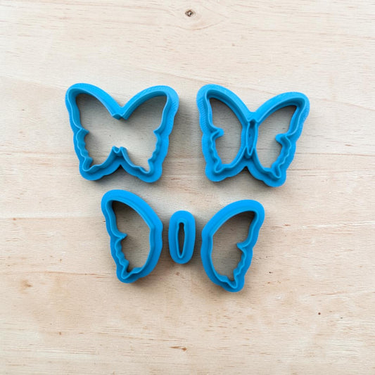 Butterfly layered cookie cutter set with outline, silhouette, and wing pieces for cookies, fondant, ceramics, and polymer clay crafts.