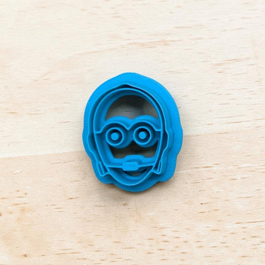 plastic C-3PO Star Wars Droid Cookie Cutter on light color wood surface