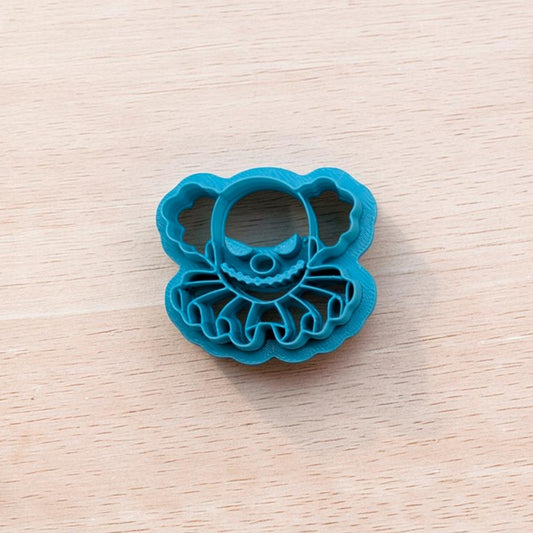   
Blue Creepy Clown Bust cookie cutter with ruffled collar detail on light wood background – Truley Unique multi‑medium baking and craft tool.