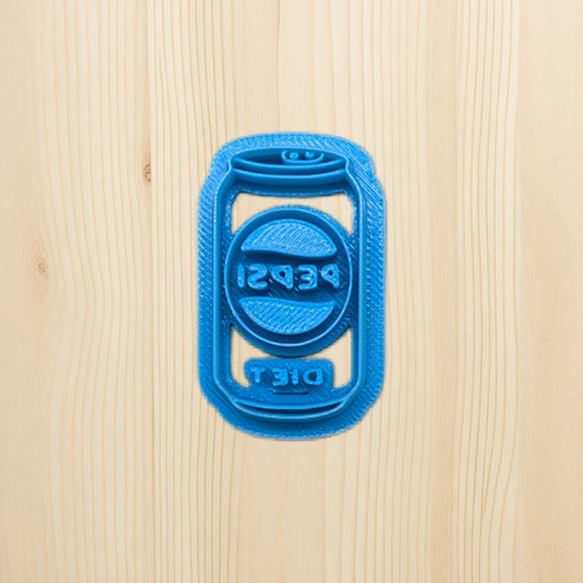 Blue 3D-printed Pepsi soda can cookie cutter on a wooden surface