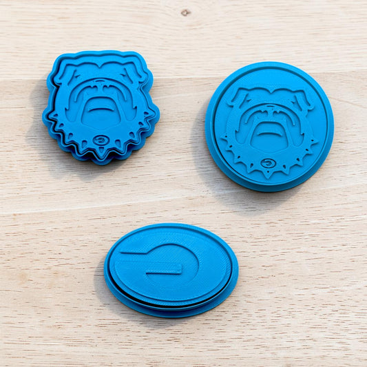 blue Georgia bulldogs inspired cookie cutter and stamp sets featuring bulldog face and letter g designs for cookies fondant and clay crafts on light wood background