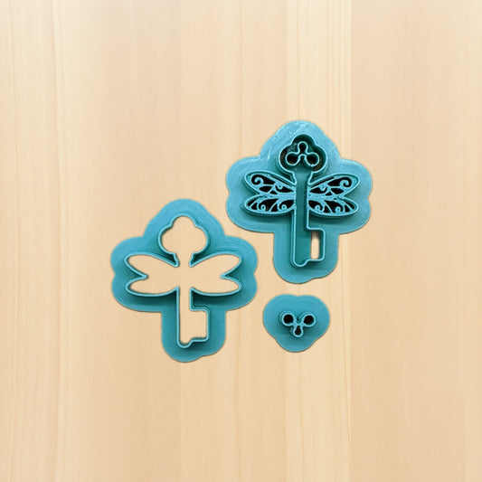 Two blue key-shaped cookie cutters on a wooden surface
