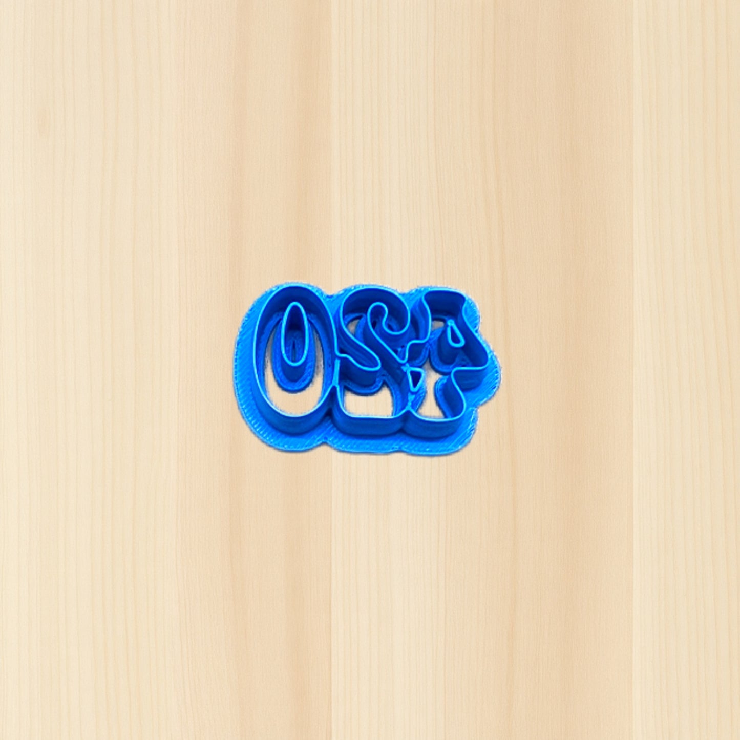 Blue cookie cutter shaped like the numbers '420' on a wood surface
