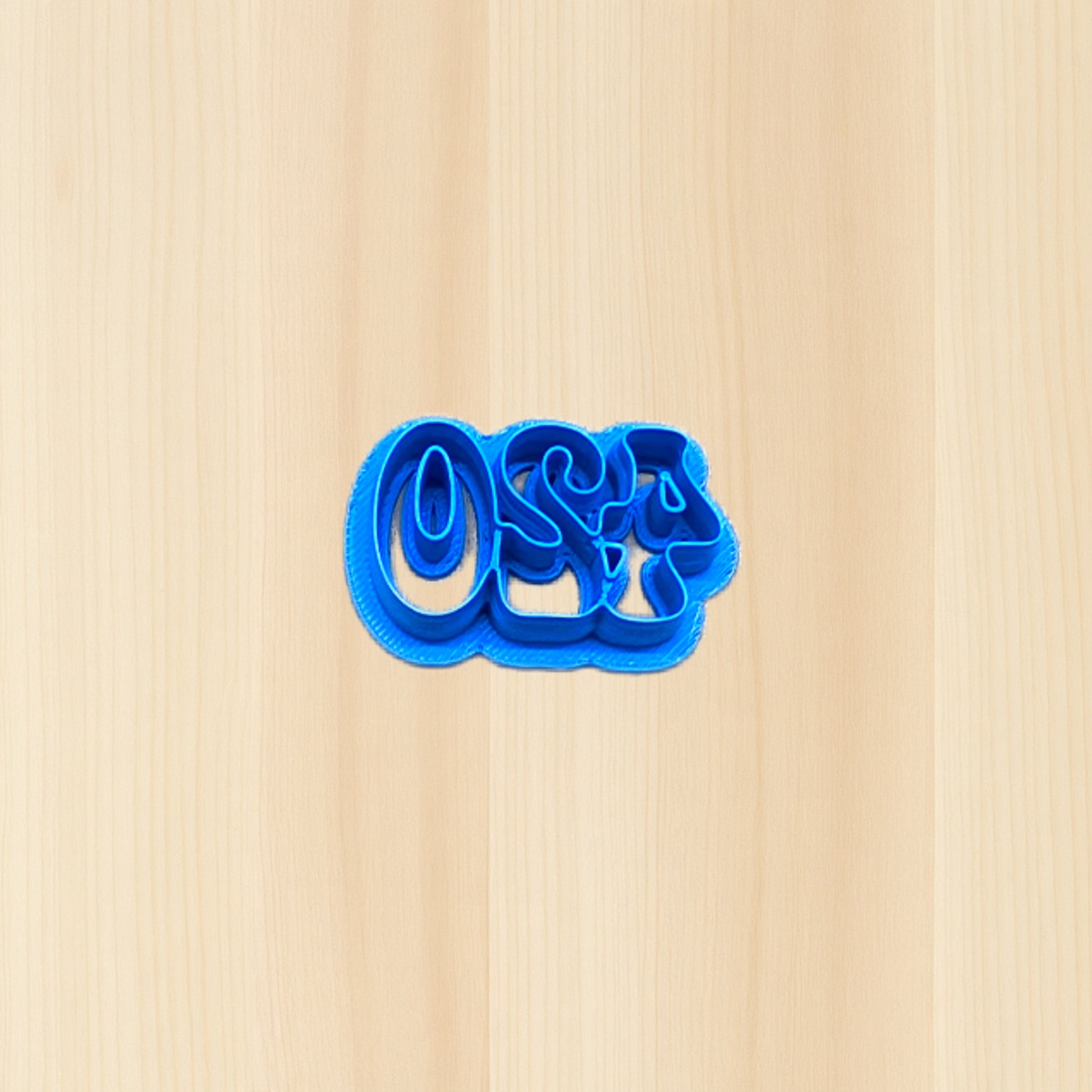 Blue cookie cutter shaped like the numbers '420' on a wood surface