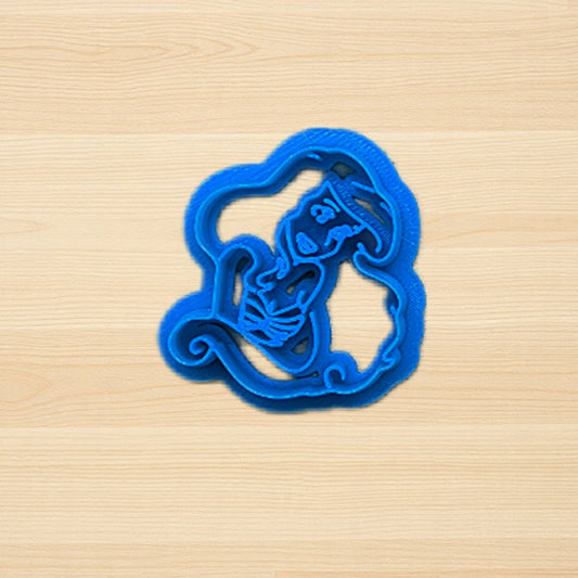Blue Princess Ariel Little Mermaid cookie cutter on a wooden surface