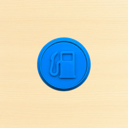 Blue fuel pump icon cookie cutter and embossing stamp on a wood background