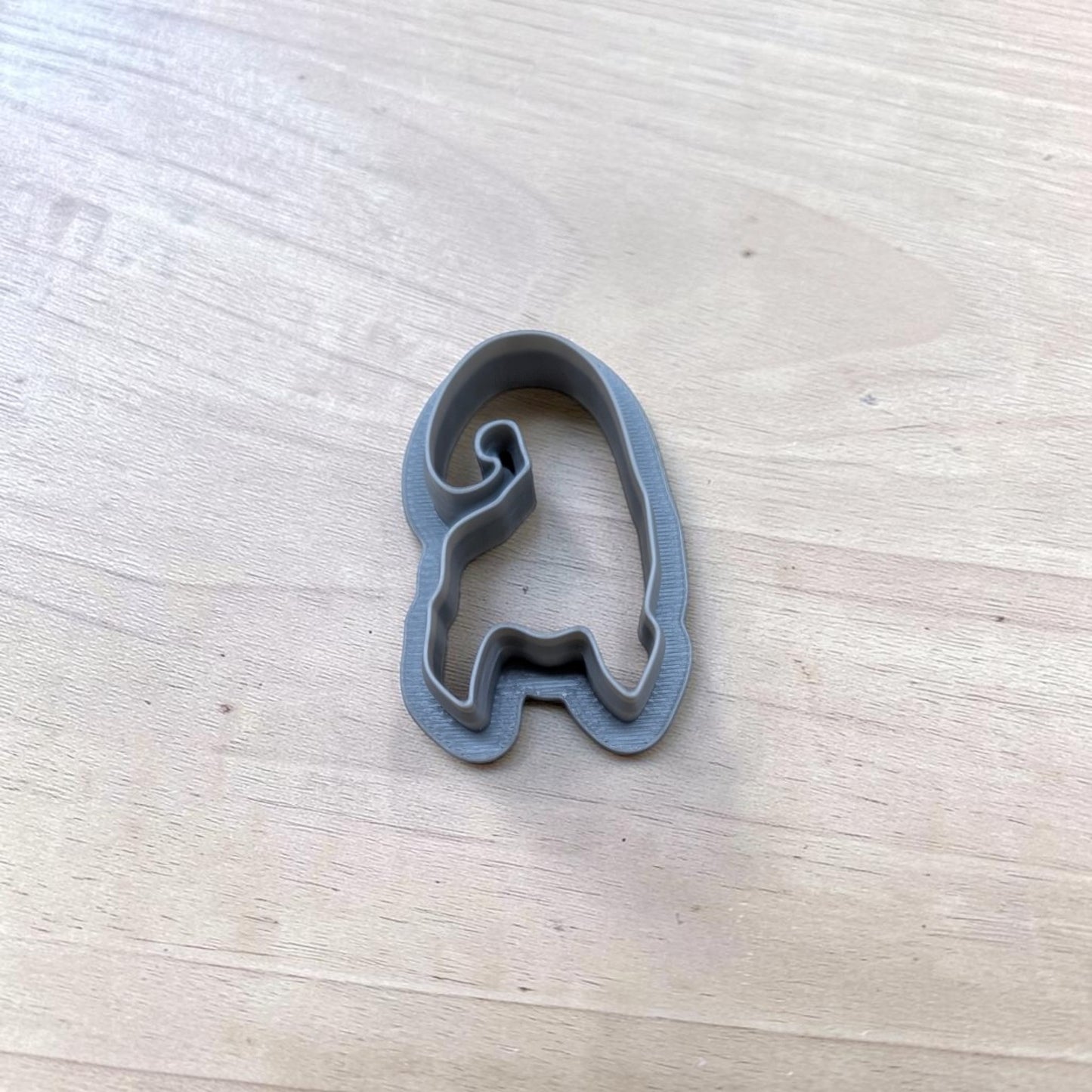Gray 3D‑printed Mary Sister hair cookie cutter on wooden surface, food‑safe polymer clay and fondant tool.