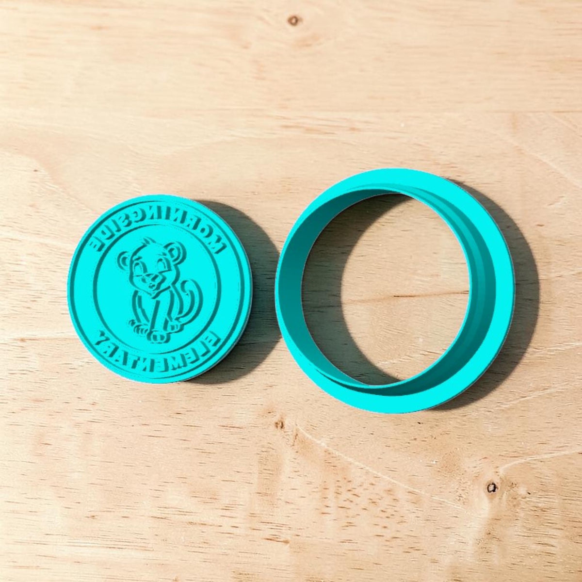Turquoise 3D printed Morningside Elementary lion emblem cookie cutter and embossing stamp set with school mascot and lettering for cookies, polymer clay, fondant, pottery and ceramics