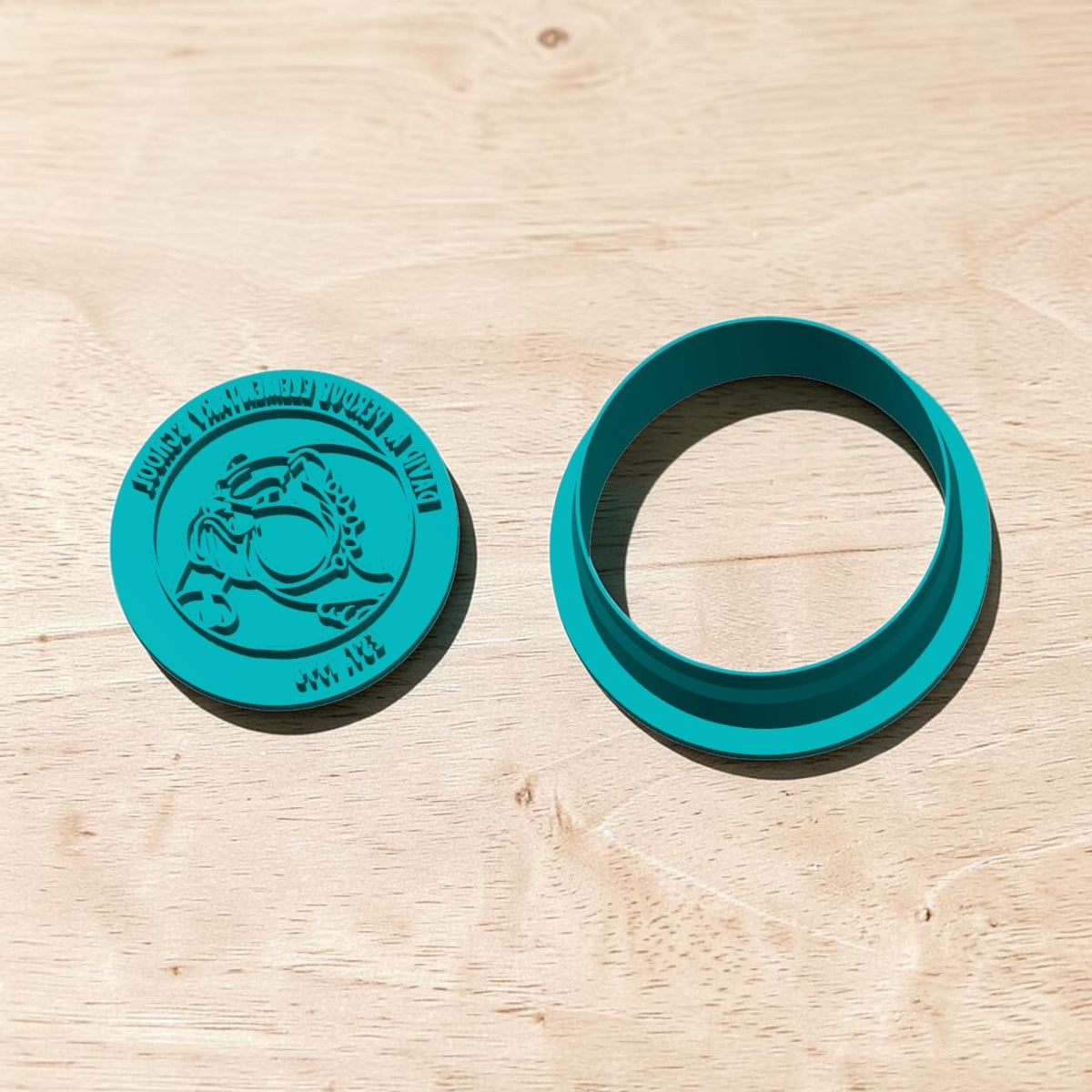 DAPES Bulldog Mascot cookie cutter and matching embossing stamp displayed on light wood background.