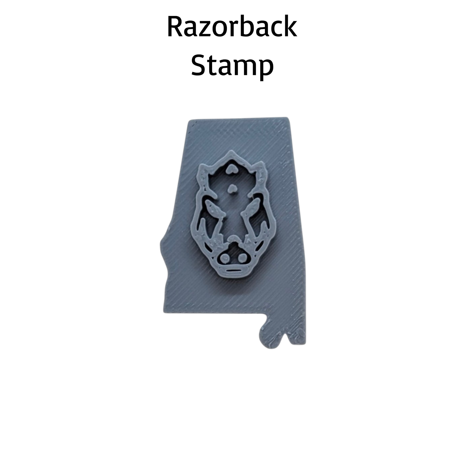 A gray Razorback Stamp mold shown on a white background with the text 'Razorback Stamp' above it. The stamp features a detailed wild boar head design.