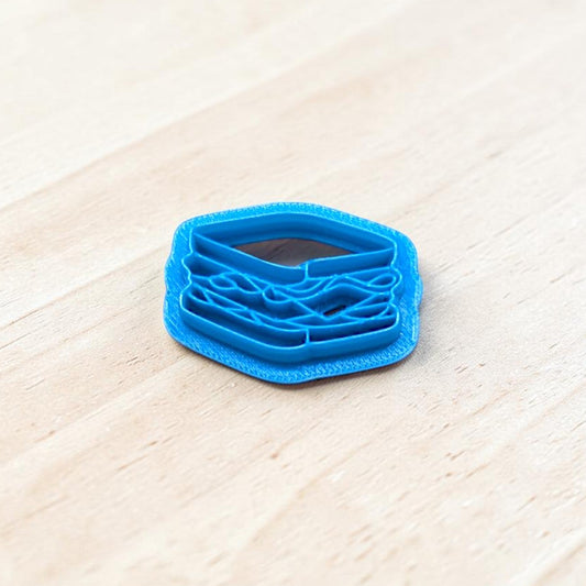Blue 3D-printed sandwich-shaped cookie cutter on a light wooden surface