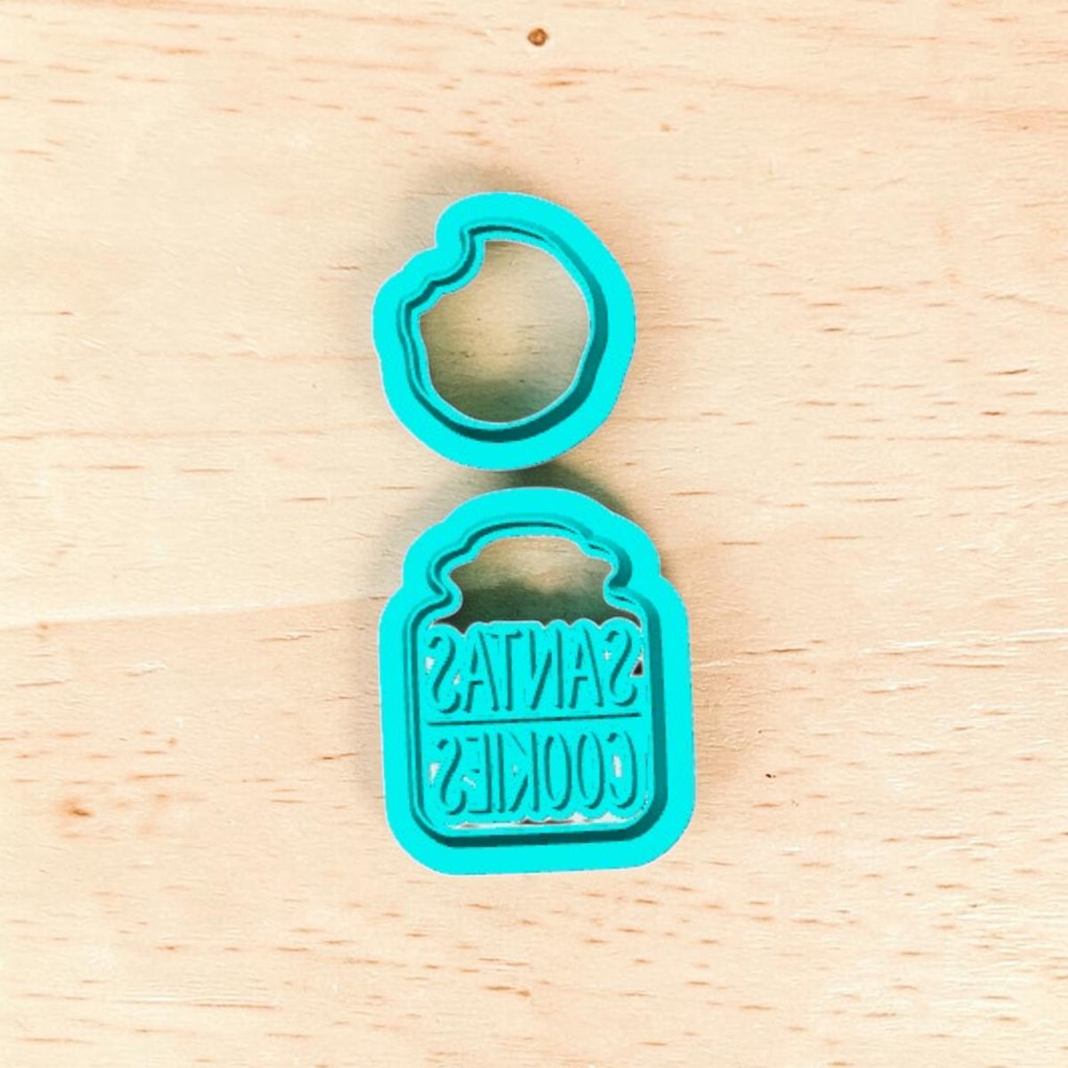 Turquoise 3D printed Santa's Cookie Jar and Bitten Cookie Cutter Set featuring a Santa's Cookies jar design and bitten cookie shape for Christmas baking, polymer clay earrings, fondant, pottery and ceramic crafts.