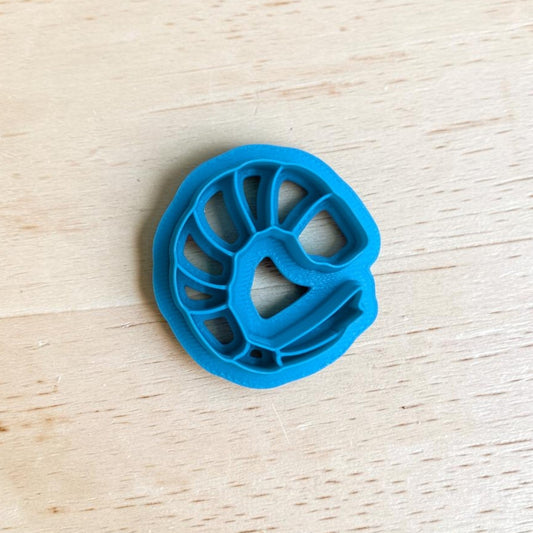 Blue plastic shrimp-shaped on a wooden surface
