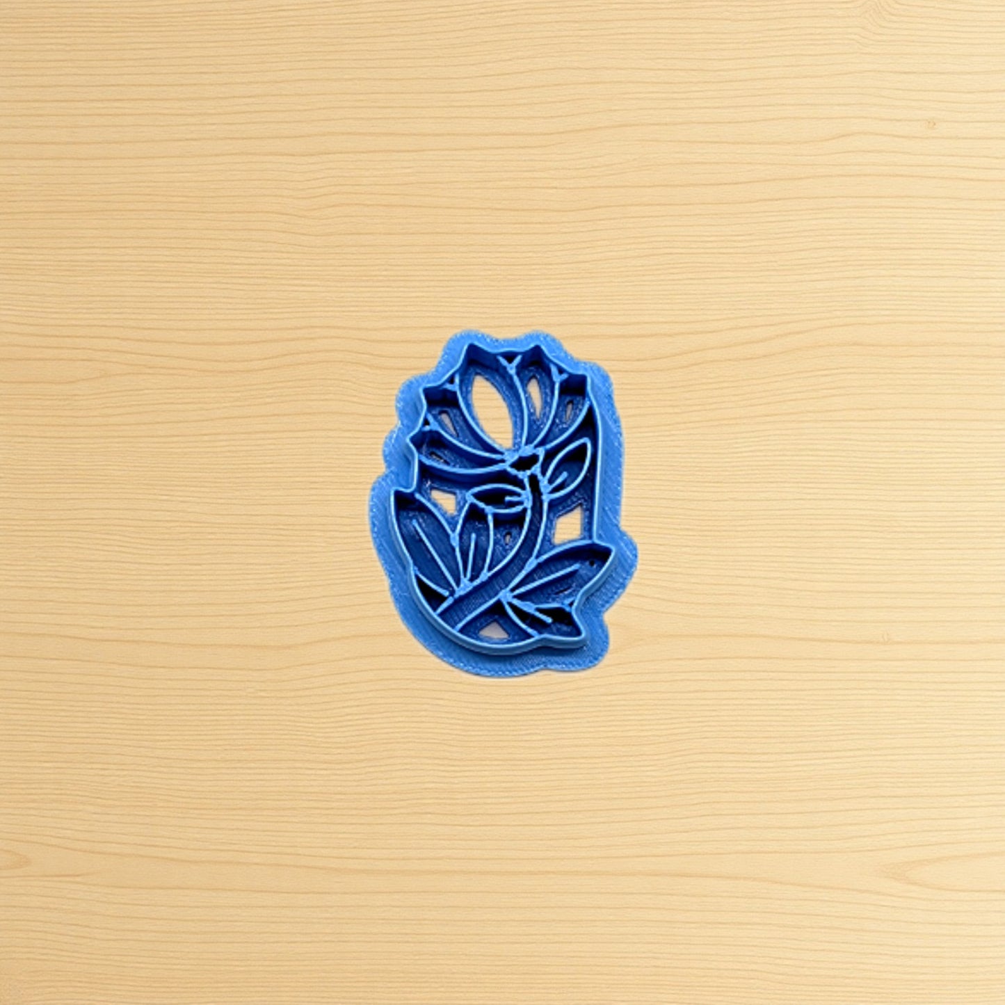 Blue floral cookie cutter on a beige surface