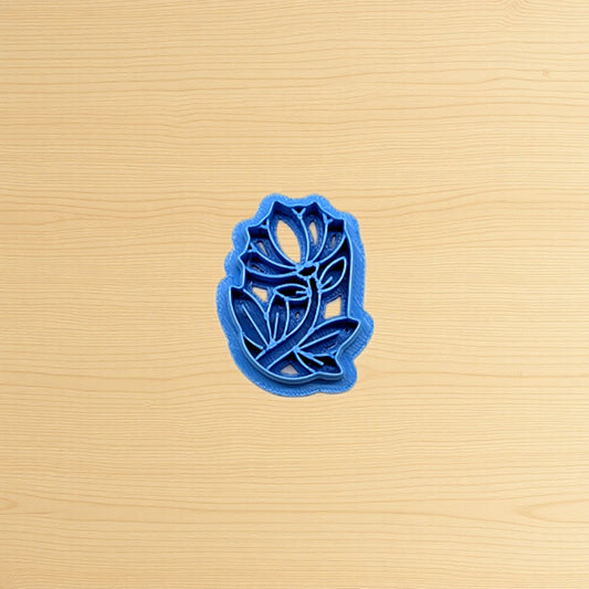 Blue floral cookie cutter on a beige surface