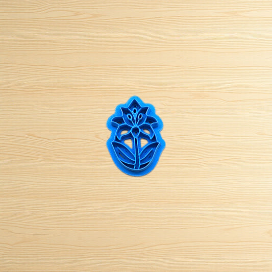 Blue floral cookie cutter on a wooden surface