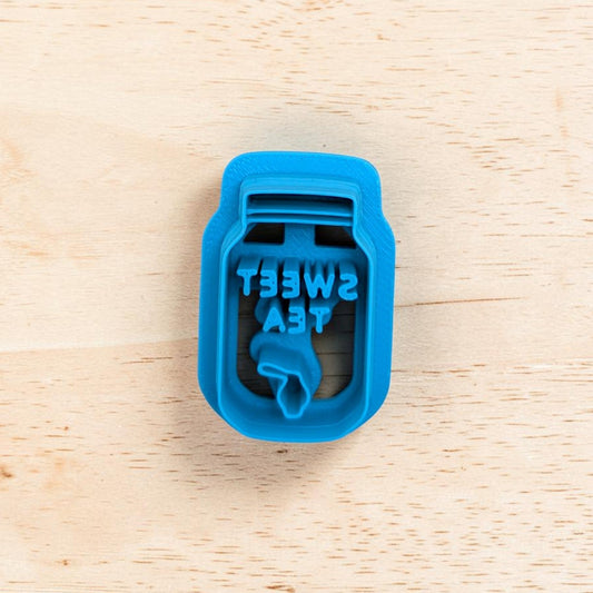 Blue mason jar cutter with 'Sweet Tea' text on a wooden surface