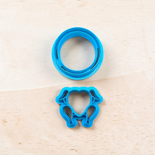 A bright blue plastic turkey shape cookie cutter and matching platter set on a light wood grain surface.