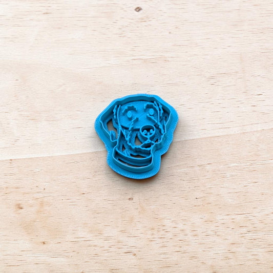 Blue dog-shaped cookie cutter on a wooden surface