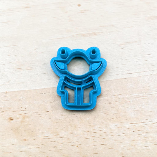 Plastic Yoda-Shaped layered cookie cutter on a light color wood surface