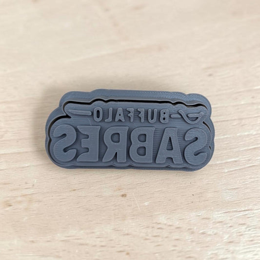 Buffalo Sabres cookie embossing stamp – gray 3D printed fondant and polymer clay tool on wood surface