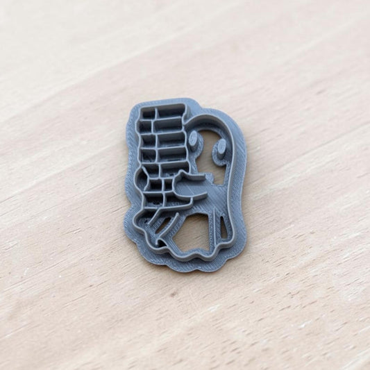 Ghost carrying book stack cookie cutter – 3D printed multi-medium tool for polymer clay, pottery, and fondant crafts.
