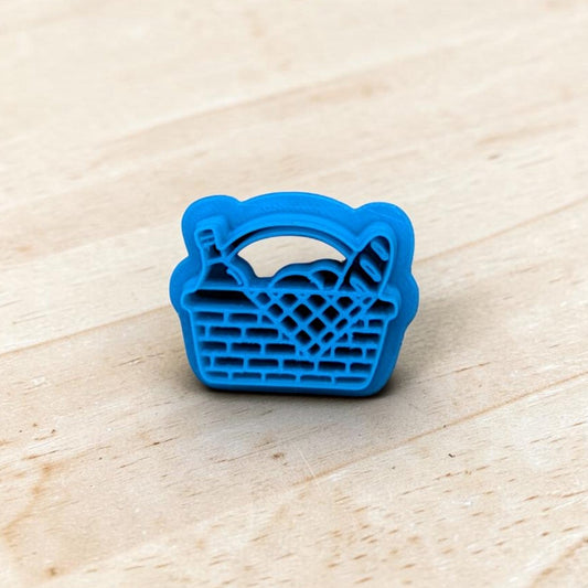 Blue basket-shaped cookie cutter on a wooden surface