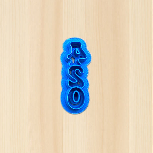 Plastic blue '420' cookie cutter on a wood surface